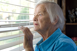 Elderly women looking by the window